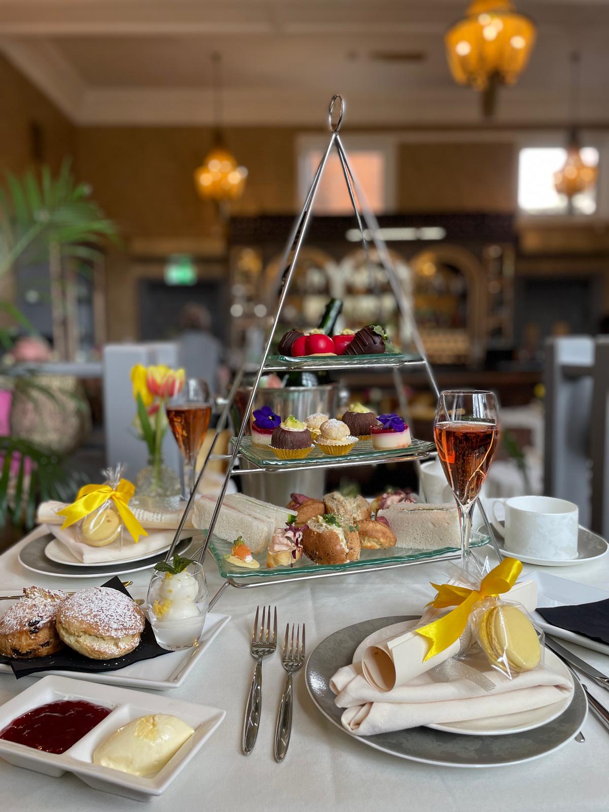Afternoon tea with warm scones, savouries and cakes